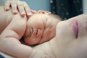 Madre con bebé en contacto piel con piel tras el parto